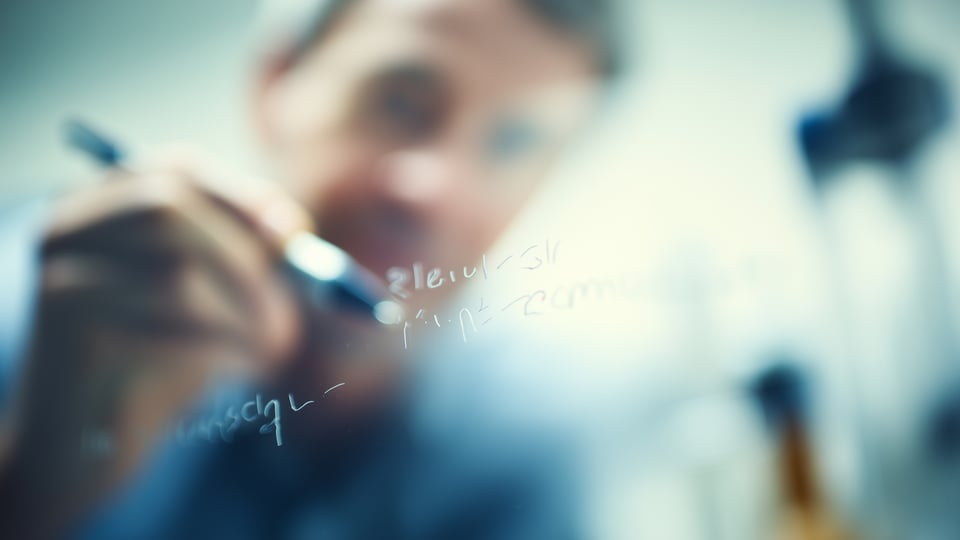 Engineer working on an equation for a solution design.