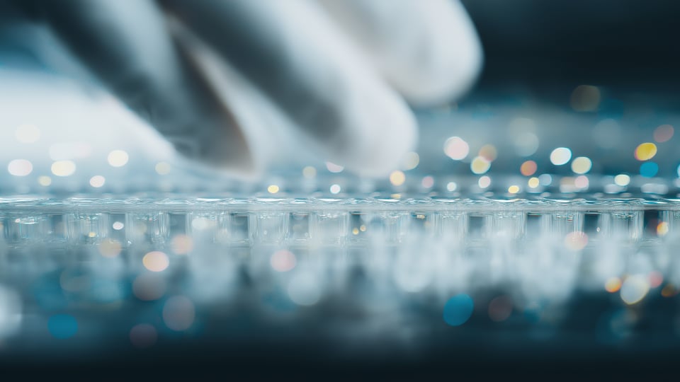 Gloved hand working with molecular diagnostic system.